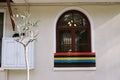 Window on white wall with multicolored windowsill. Tranquill scene Royalty Free Stock Photo
