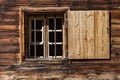 Window of a wooden alpine hut. Rustic background Royalty Free Stock Photo