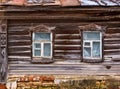 The window with the wooden carved architrave in the house