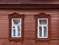 The window with the wooden carved architrave in the house