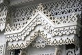 A window of a wooden county house decorated by white frames