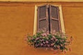 window with wooden shutters and geraniums Royalty Free Stock Photo