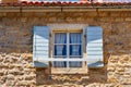 window with wooden shutters, street view of the old town of Budva in Montenegro, medieval European architecture, city streets, red Royalty Free Stock Photo