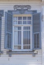 Window with wooden shutters on white wall building, Turkey