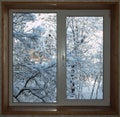 Window with a wooden window sill overlooking the snow-covered ga