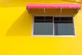 Window on yellow wall with red splashboard Royalty Free Stock Photo