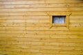 Window on the yellow wooden building facade in countryside, open window in the street. Minimal composition. Rustic wallpaper