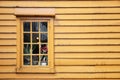 Window of yellow wooden house Bryggen street Bergen, Norway Royalty Free Stock Photo