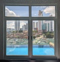 From the window you can see the beautiful swimming pool and the beautiful view of the city& x27;s construction Royalty Free Stock Photo