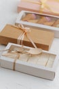 Windowed and sealed ribbon tied boxes with sweets. On white surface