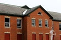 Old broken windows on abandoned brick asylum building Royalty Free Stock Photo