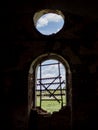 Windows of an ancient temple, in the wall of red brick, in the form of an arch. The hole in the wall is sealed with metal bars