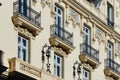 Windows and balconies on baroque antique facade with elegant deco details in Madrid, Spain