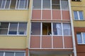 Windows and balconies of a block of flats. The cat is sitting on the balcony. The photo Royalty Free Stock Photo
