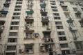 Windows and balconies of residential buildings with lots of air conditioning and clothes hanging at windows in rural modern Beijin