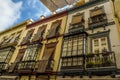 Windows, balconies and sunshades in a street in Seville, Spain Royalty Free Stock Photo