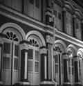 Windows and balconies in typical colonial architecture in Singapore China Town shot in black and white analogue film photography Royalty Free Stock Photo