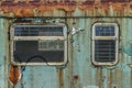 The windows of a blue abandoned wagon