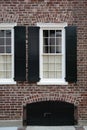 Windows, brick wall, black shutters Royalty Free Stock Photo