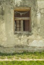 Windows with broken glass on the abandoned white village house