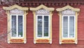 Windows with carved wooden architraves. Facade of typical russian merchant house. Royalty Free Stock Photo