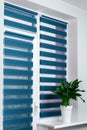 Windows with closed modern horizontal blinds indoors closeup. Window roller, duo system day and night. Beautiful blue Royalty Free Stock Photo