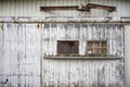 Windows closed by a piece of plywood on the peeling wall of an old industrial warehouse building Royalty Free Stock Photo