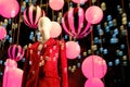 Windows clothing stores with balloons and lanterns on the eve of Christmas and new year celebrations. Woman mannequin in a suit in Royalty Free Stock Photo