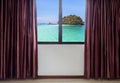 Windows with curtains and blinds looking out the window frame meet tropical seaside view Royalty Free Stock Photo