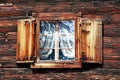 Windows with curtains and shutters on an old wooden house Royalty Free Stock Photo