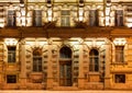 Windows and door on night facade of apartment building Royalty Free Stock Photo