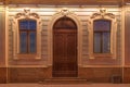 Windows and door on night facade of apartment building Royalty Free Stock Photo