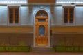 Windows and door on night facade of apartment building Royalty Free Stock Photo