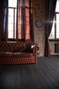 Windows at empty Library room with a brick wall. Leather sofa in a vintage style. The furniture in the room. Dark brown Royalty Free Stock Photo