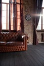 Windows at empty Library room with a brick wall. Leather sofa in a vintage style. The furniture in the room. Dark brown Royalty Free Stock Photo