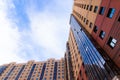 Windows of a high multi-storey residential building. Residential apartment building. Blue sky. Place under the text. . An article