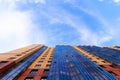 Windows of a high multi-storey residential building. Residential apartment building. Blue sky. Place under the text. . An article