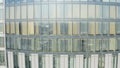 Windows of high-rise building on background city. Stock footage. Top view of panoramic Windows of skyscraper on