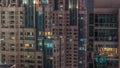 Windows in high-rise building exterior in the late evening with interior lights on timelapse Royalty Free Stock Photo