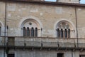 Windows at the inner yard of medieval palace Palazzo del Broletto, Brescia, Lombardy, Italy