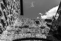 Windows inside of the massive high walls of an old medieval castle b/w