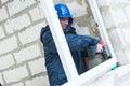 Windows installation. construction workers installing frame into aperture Royalty Free Stock Photo
