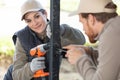 windows installation workers male and female Royalty Free Stock Photo