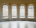 Windows with iron decorated grid, yellow wall, and marble floor Royalty Free Stock Photo