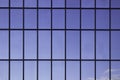 Windows in an office building, background. Blue sky reflected in the glass, black frames Royalty Free Stock Photo