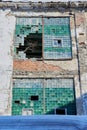 Windows of an old abandoned factory building with broken glass. A crumbling brick wall Royalty Free Stock Photo