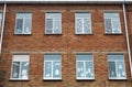 Windows of  old red brick building. Christmas decor on the glass Royalty Free Stock Photo