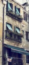 Windows with plants of old house in a street in Venice, Italy Royalty Free Stock Photo