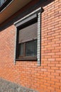 Windows with rolling shutter on the new brick house construction facade exterior