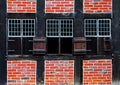 Windows with shutters in brick wall of the half timbered house Royalty Free Stock Photo